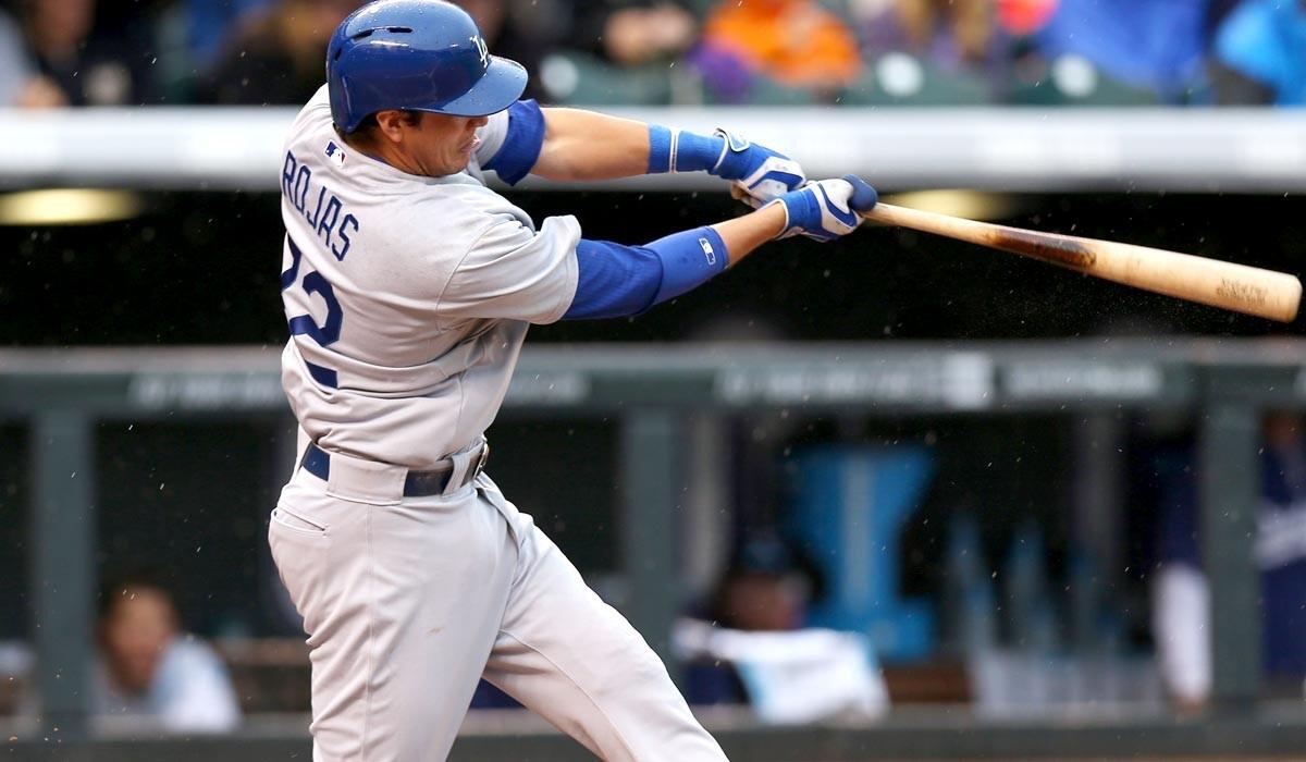 Dodgers second baseman Miguel Rojas, who flied out on this swing in the fifth inning, collected his first hit and RBI in the majors on Sunday in Denver.