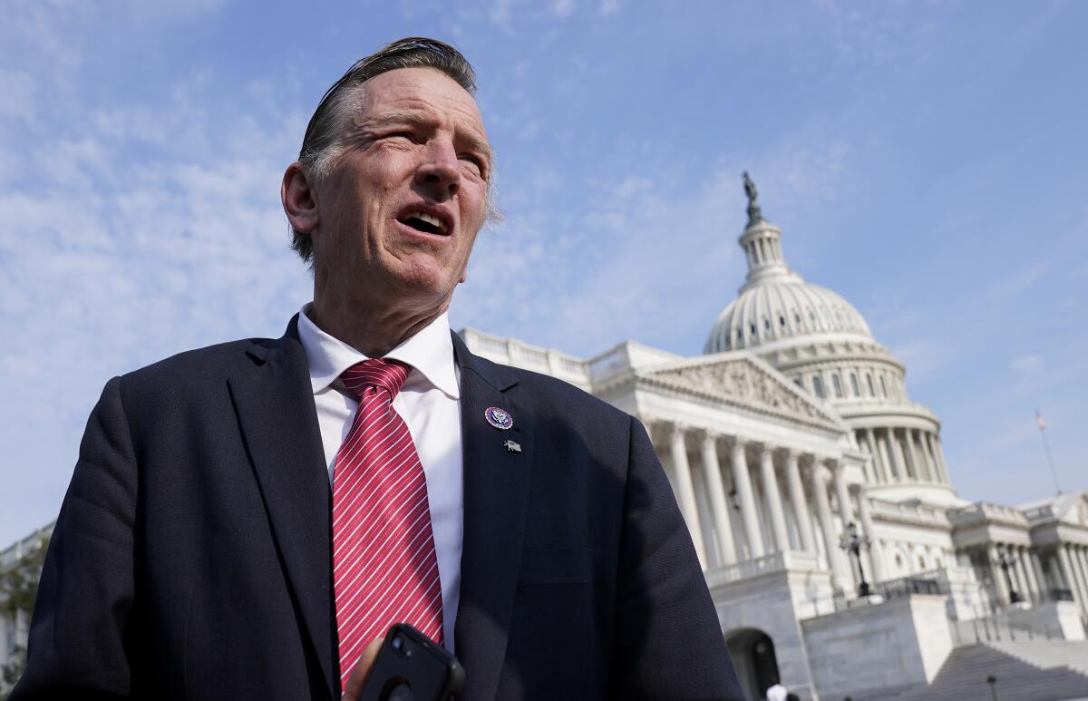 FILE - Rep. Paul Gosar, R-Ariz., waits for a news conference about the Delta variant of COVID-19 and the origin of the virus, at the Capitol in Washington, on July 22, 2021. In the past week, Gosar tweeted a video showing a character with his face killing a figure with Rep. Alexandria Ocasio-Cortez's face. Several of the 13 House Republicans who backed a bipartisan infrastructure bill said they faced threats after their vote. In one profanity-laced voicemail, a caller labeled Rep. Fred Upton a “traitor” and wished death for the Michigan Republican, his family and staff. (AP Photo/J. Scott Applewhite, File)