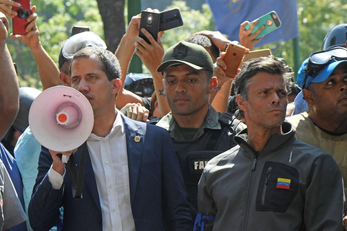 Venezuelan opposition leader and self-proclaimed acting president Juan Guaido (L) speaks to supporters next to high-profile opposition politician Leopoldo Lopez (R), who had been put under home arrest by Venezuelan President Nicolas Maduro's regime, and members of the Bolivarian National Guard who joined his campaign to oust Maduro, in Caracas on April 30, 2019. - Guaido said there is 'no turning back' in the bid to oust Maduro. (Photo by Federico PARRA / AFP)FEDERICO PARRA/AFP/Getty Images ** OUTS - ELSENT, FPG, CM - OUTS * NM, PH, VA if sourced by CT, LA or MoD **