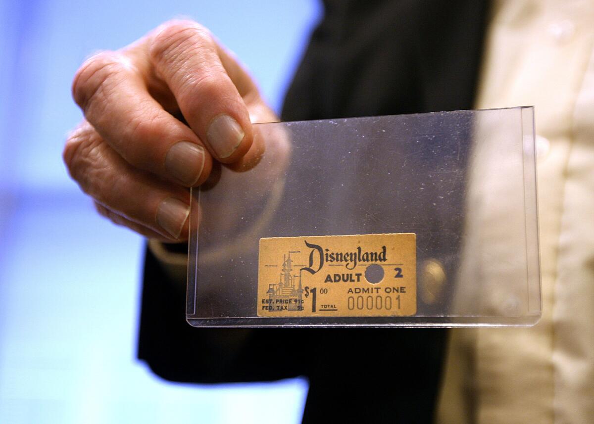 The first Disneyland admission ticket ever sold is held by archivist Dave Smith at Walt Disney Studios in Burbank in April 2010.