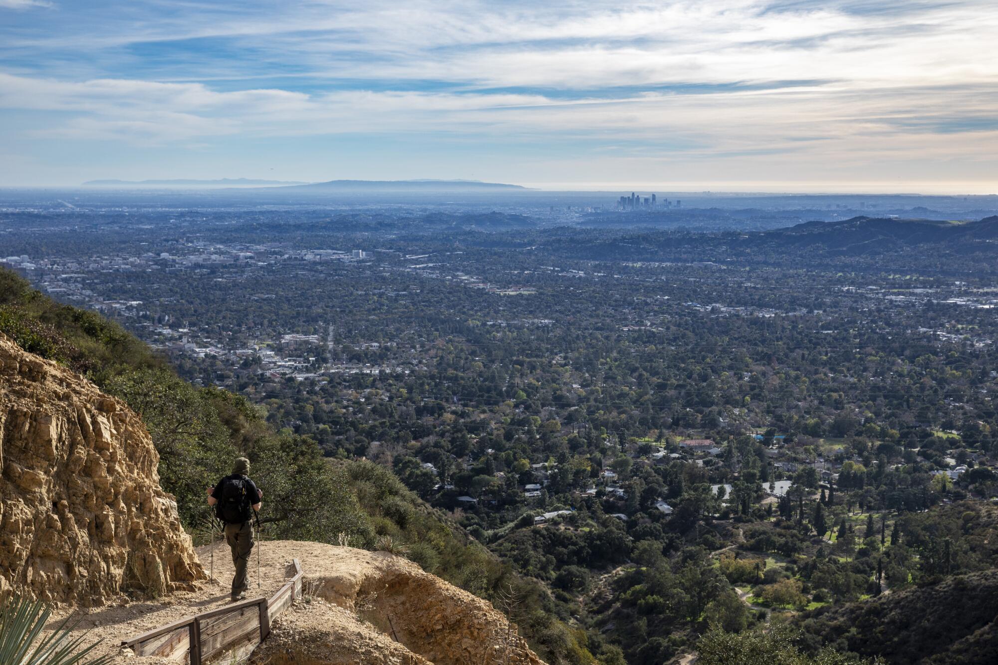A hiker takes in the views from atop Echo Mountain.
