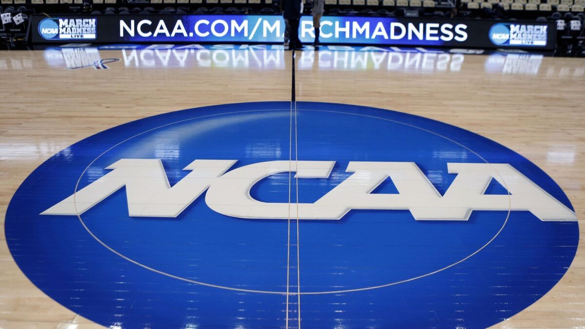 The NCAA logo is displayed at center court as work continues for the NCAA tournament in Pittsburgh on March, 18, 2015.