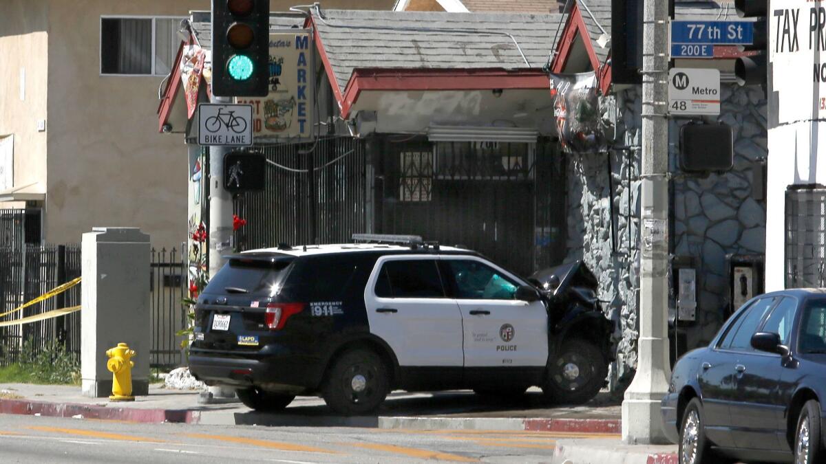 A police SUV rests Thursday where it crashed near the intersection of 77th and San Pedro streets in Los Angeles.