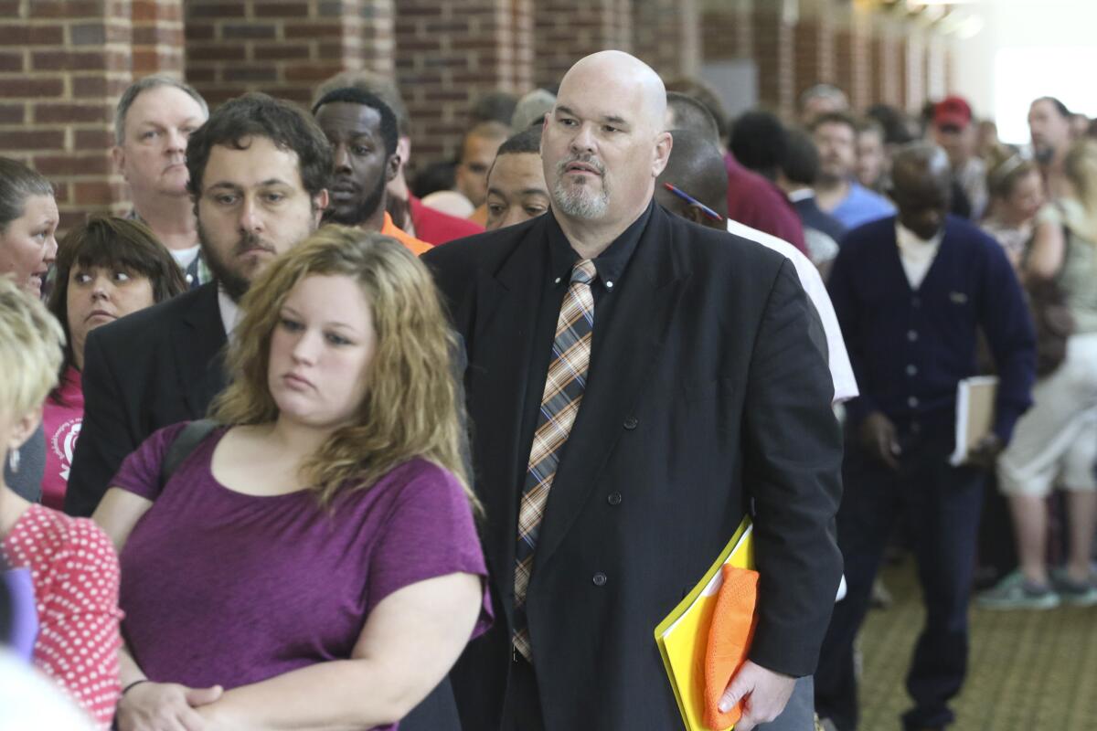 David Dunn from Chickamauga, Ga., right, stands in line with hundreds of other job seekers in Ringgold, Ga., at a 15-county job fair.