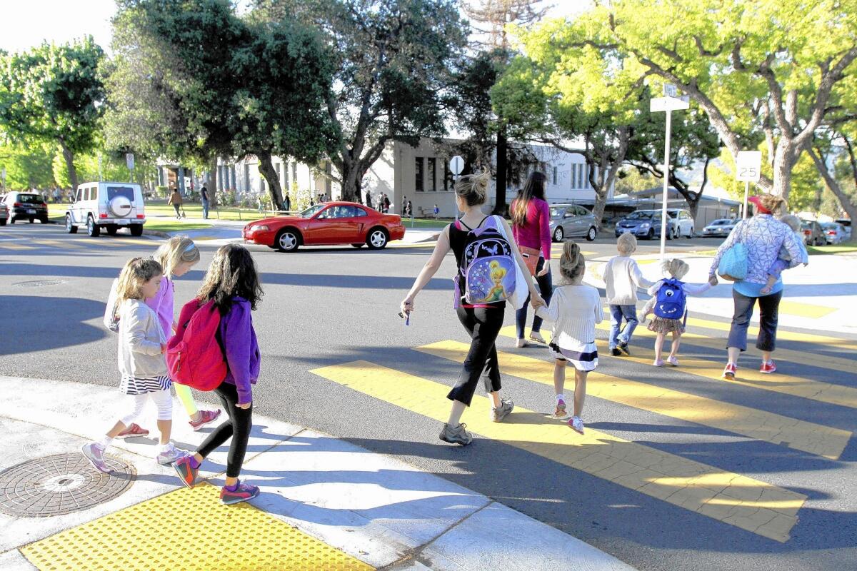 A group of parents and children cross at Allen Avenue and Bel Aire Drive in front of Balboa Elementary School in Glendale on Thursday, April 10, 2014. There are no crossing guards at this location.