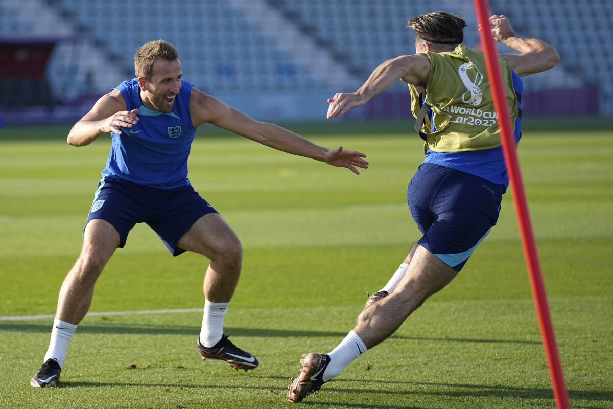 England's Harry Kane, left, and England's Jack Grealish take part in drills at Al Wakrah Sports Complex on the eve of the group B World Cup soccer match between England and Wales, in Al Wakarah, Qatar, Monday, Nov. 28, 2022. (AP Photo/Abbie Parr)