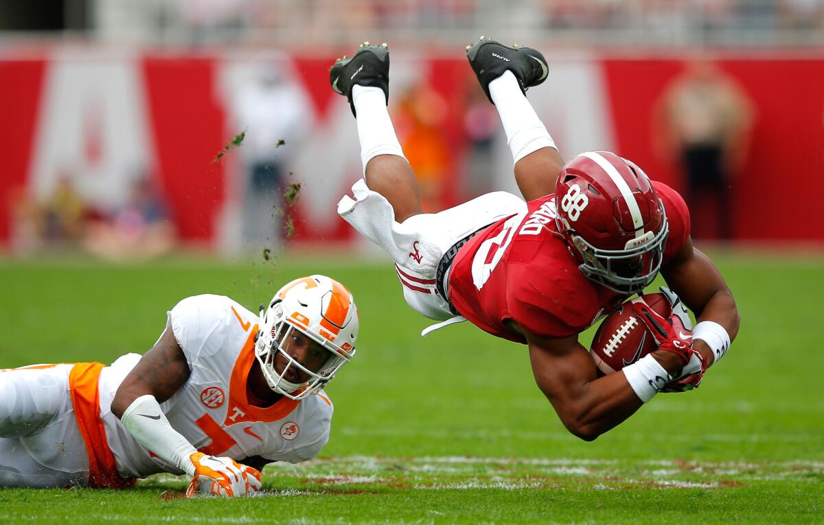 Tennessee receiver O.J. Howard dives for extra yards after making a reception against Tennessee defensive back Cameron Sutton on Saturday.