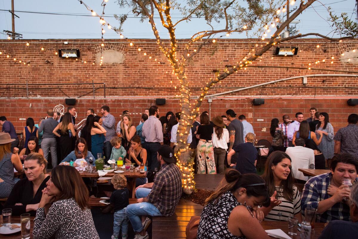 Patrons fill the outdoor patio at Everson Royce Bar