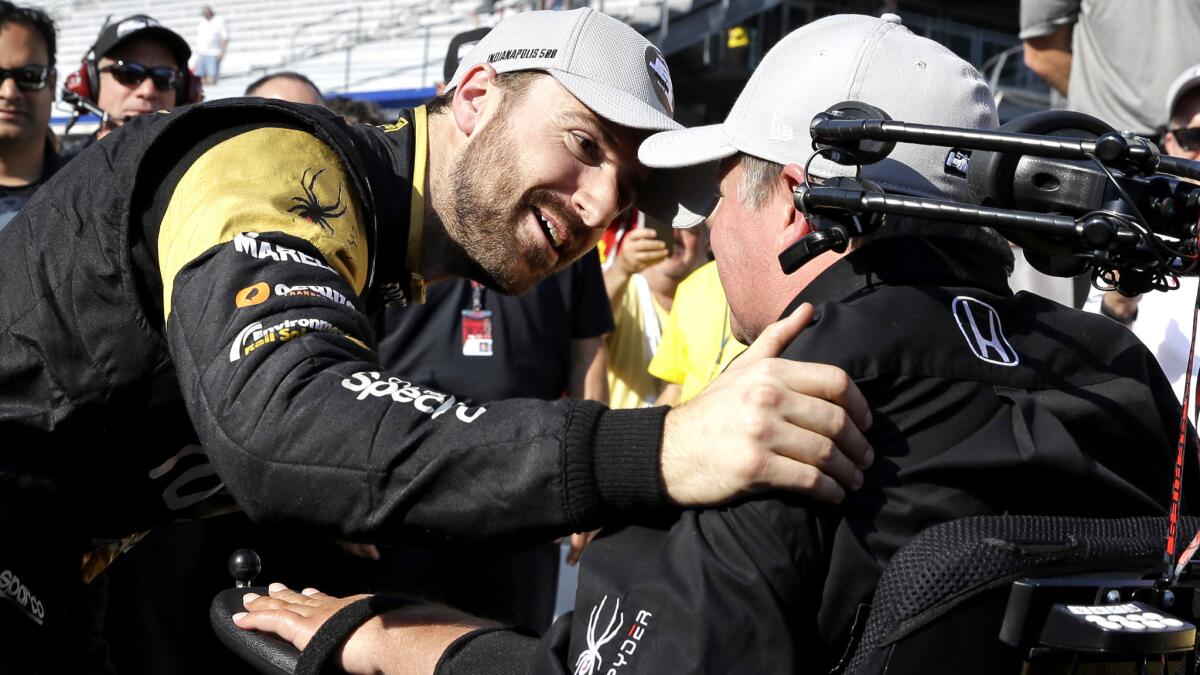 IndyCar driver James Hinchcliffe celebrates with car owner Sam Schmidt after winning the pole during qualifying for the Indianapolis 500.