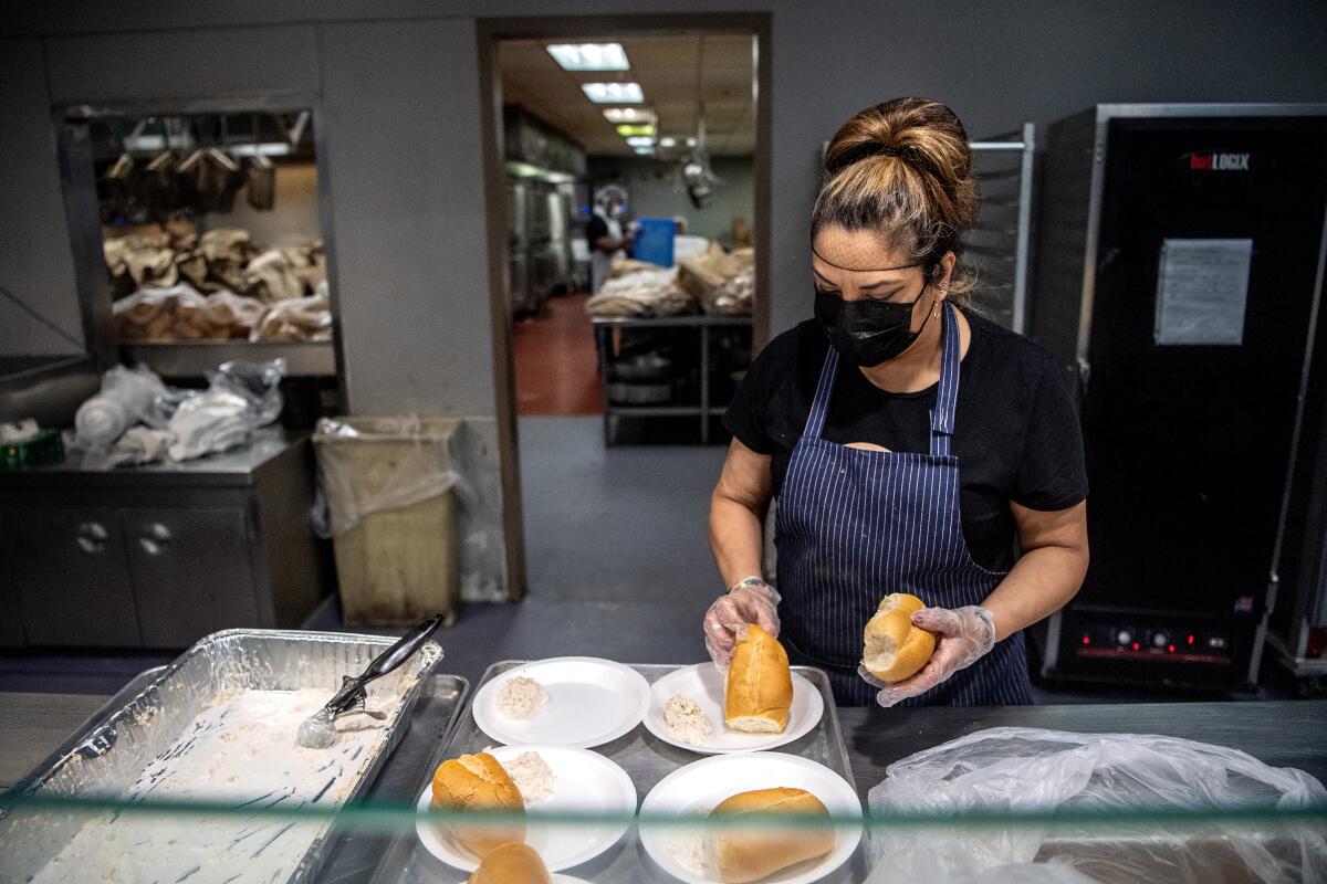 Margarita Motero prepares meals at Union Rescue Mission, which is still serving hot meals  during the COVID-19 pandemic.