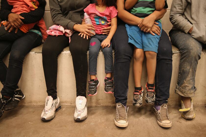 Women and children sit in a holding cell at a U.S. Border Patrol processing center after being detained by agents near McAllen, Texas, in September.