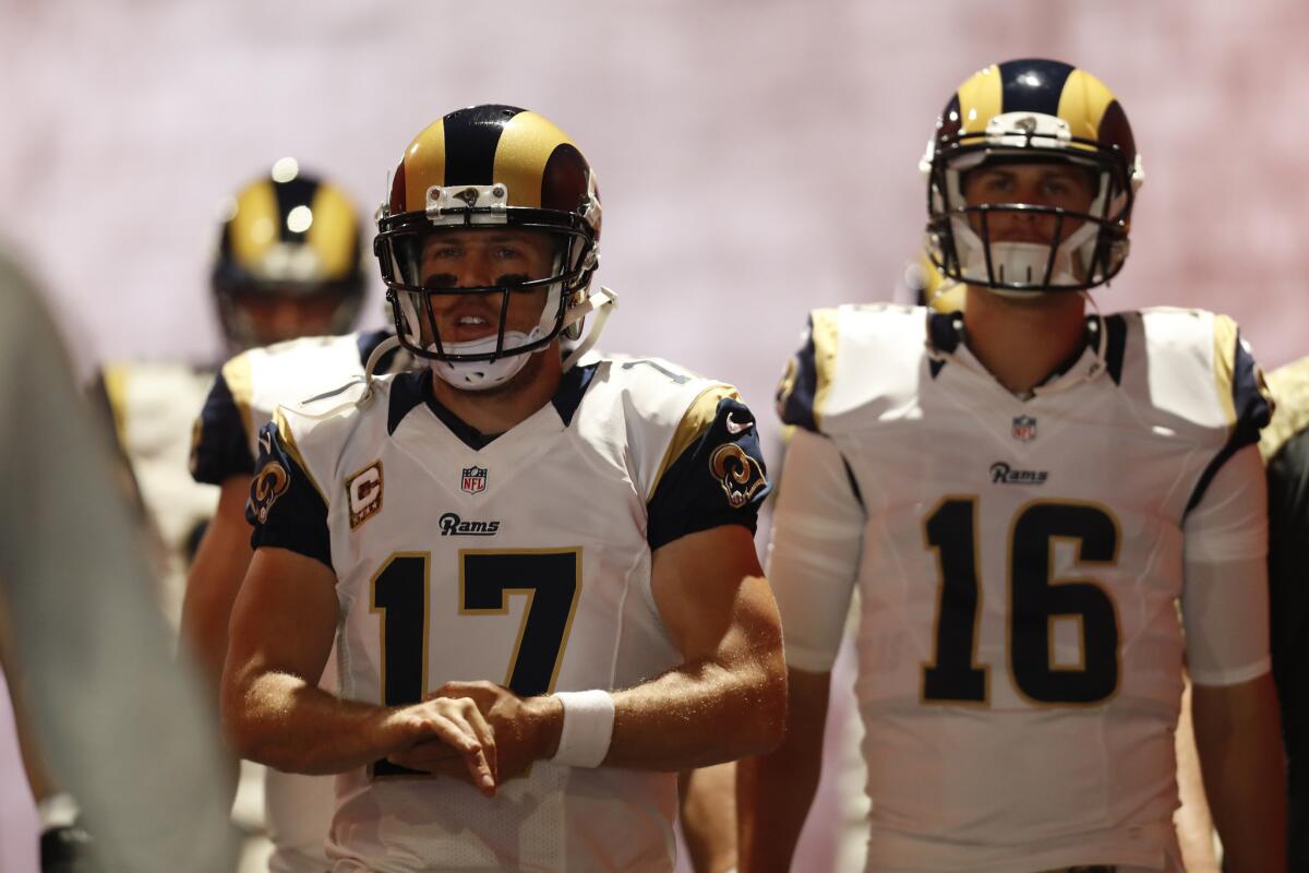Rams quarterback Case Keenum (17) and quarterback Jared Goff (16) walk to the field before a game against the Carolina Panthers on Nov. 6.
