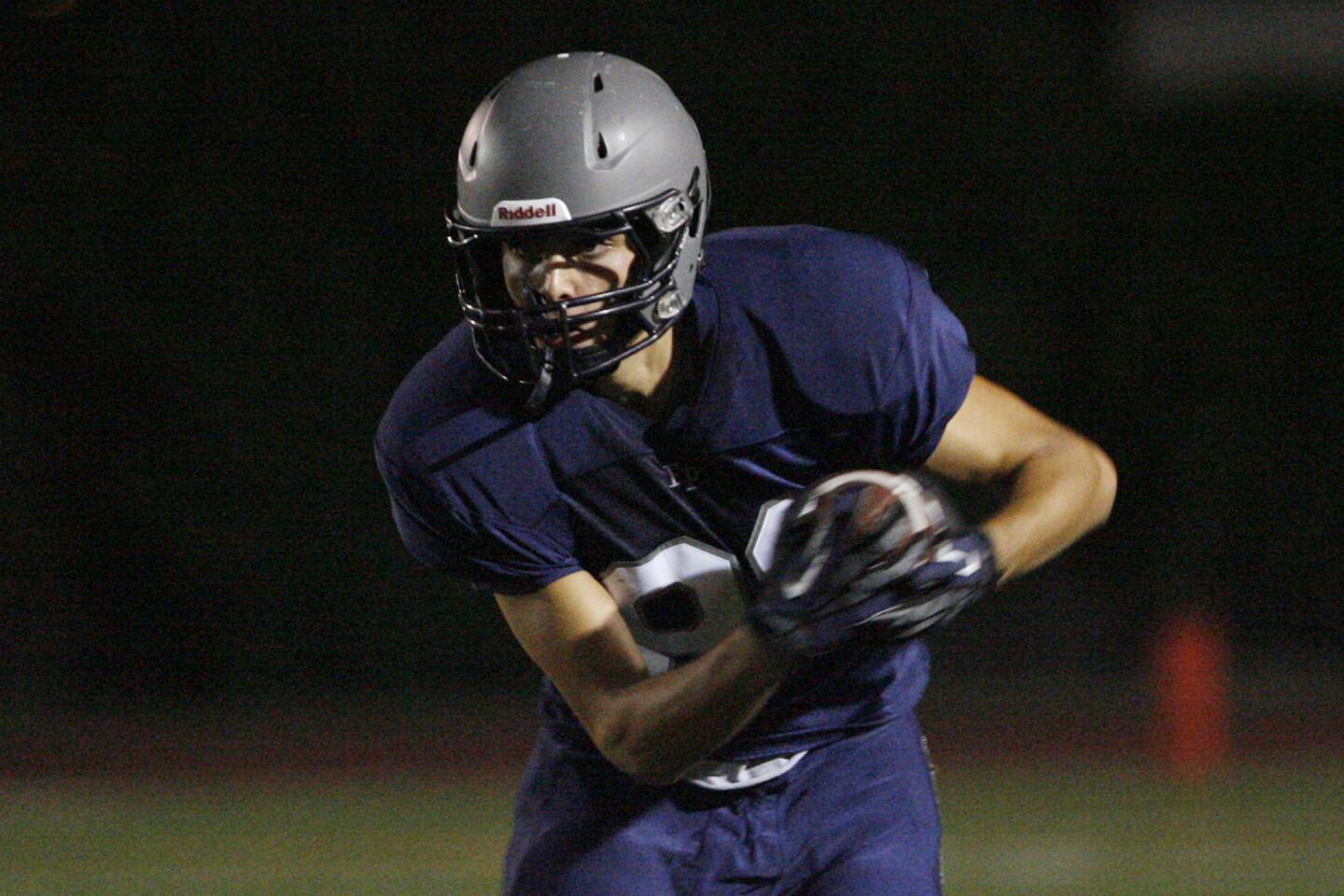 Flintridge Prep's Kareem Ismail runs with the ball during a game against Malibu at Occidental College in Los Angeles on Friday, September 21, 2012.