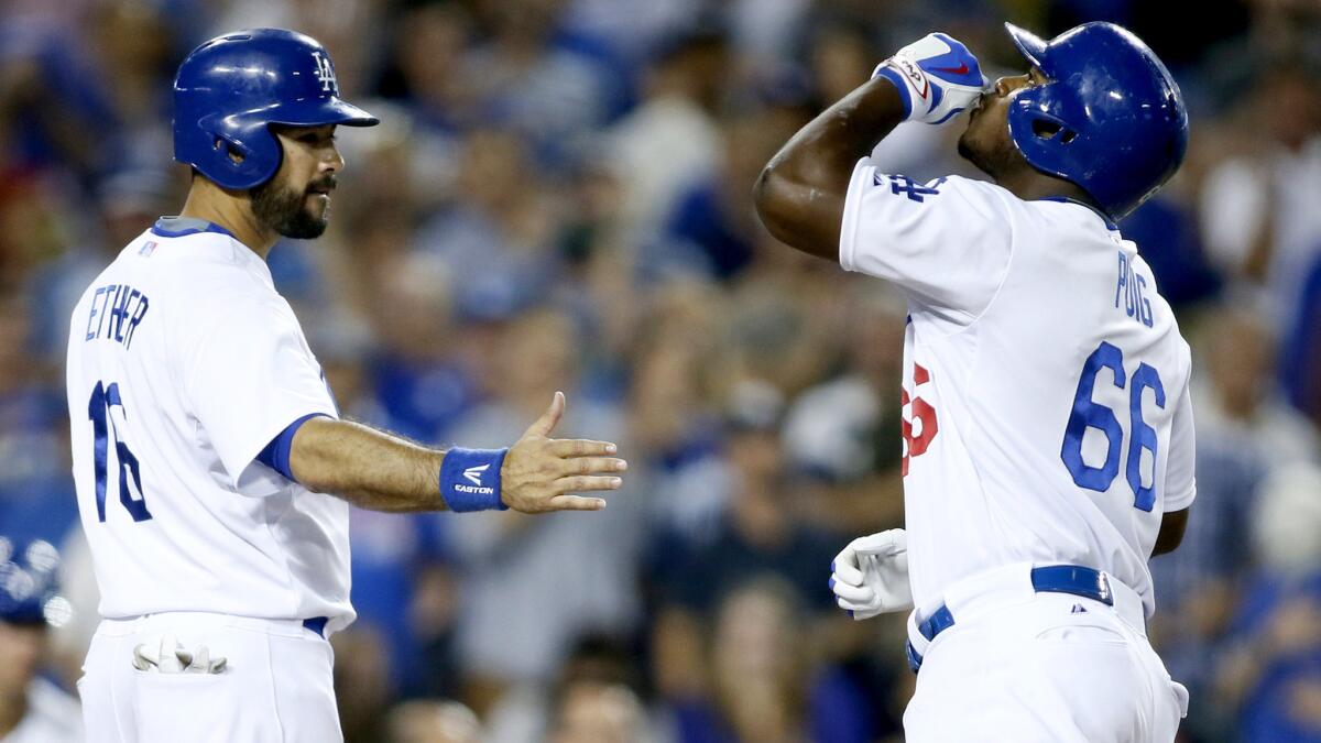 Dodgers right fielder Yasiel Puig (66) celebrates his two-run home run with teammate Andre Ethier during a 5-0 victory over the Nationals on Tuesday. The win broke a four-game losing streak, but did it restore the fans' faithin the club?