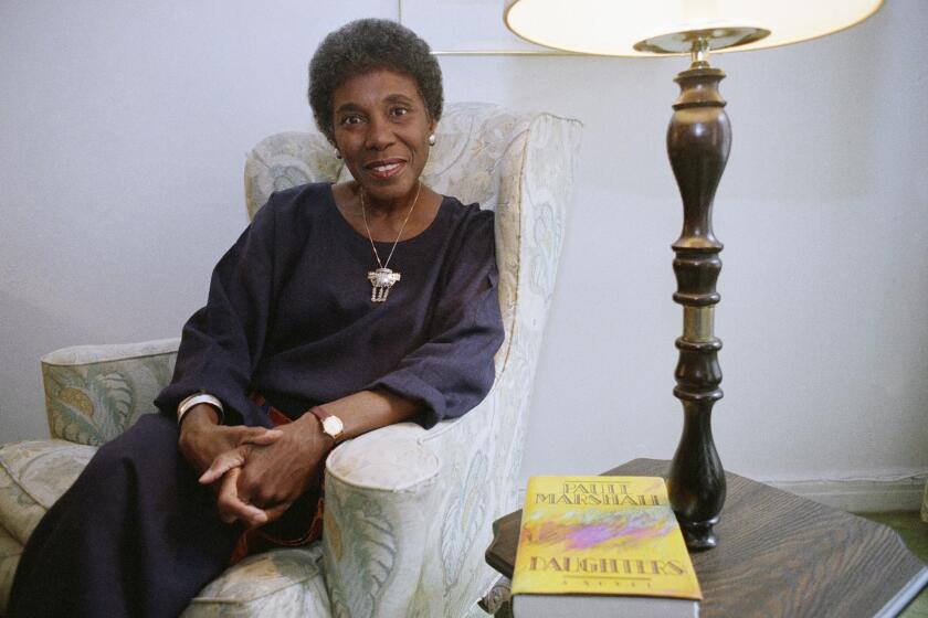 FILE - In this Nov. 22, 1991 file photo, author Paule Marshall poses during an interview, in New York. The acclaimed fiction writer has died at 90. Marshall’s son, Evan K. Marshall, told The Associated Press that she died Monday, Aug. 12, 2019 in Richmond, Va. Marshall was an exuberant and sharpened storyteller who drew upon classic and vernacular literature and her mother's kitchen conversations for such fiction as "Brown Girl, Brownstones," "Daughters" and "Praisesong for the Widow.” (AP Photo, File)