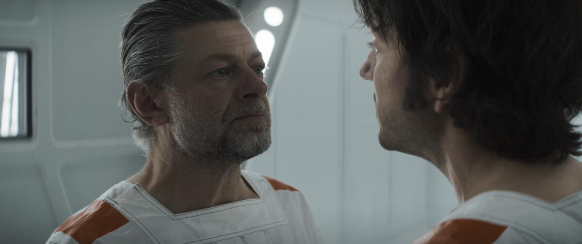 Two detainees in a space prison (played by Andy Serkis and Diego Luna) argue over whether to lead a revolt in "Andor."
