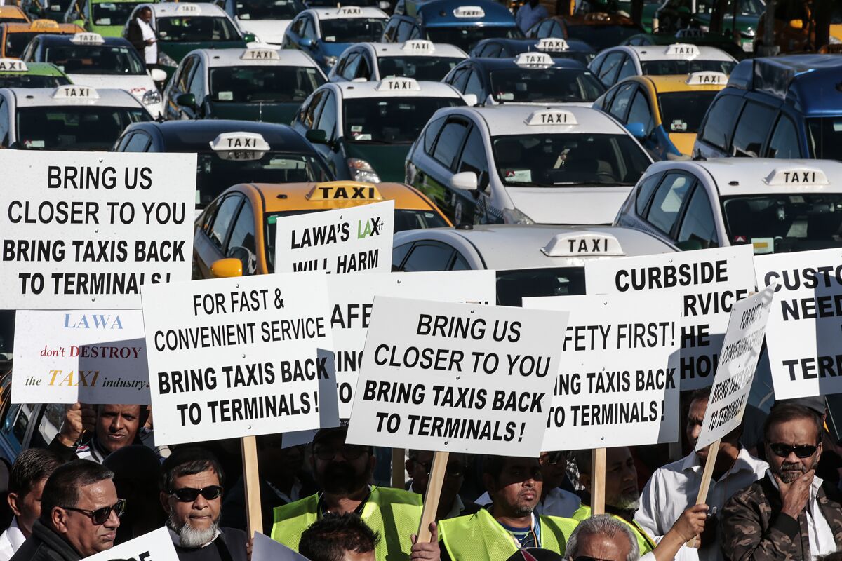 Taxi drivers demonstrate at LAX in January to call for a return to curbside pickups.