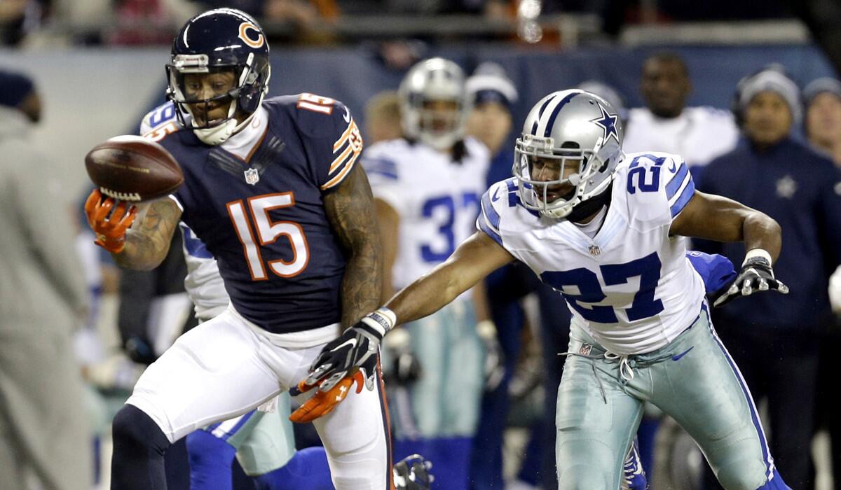 Bears wide receiver Brandon Marshall (15) makes a catch against Cowboys safety J.J. Wilcox (27) before getting injured in the first half Thursday night.