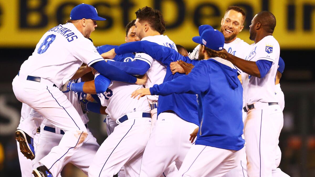 Kansas City Royals players celebrate their 9-8 win in 12 innings over the Oakland Athletics in the American League wild-card game on Tuesday. The Royals will play the Angels in Game 1 of the AL division series Thursday.