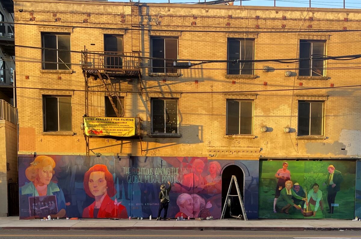 A mural of a Holocaust hero on an exterior wall.