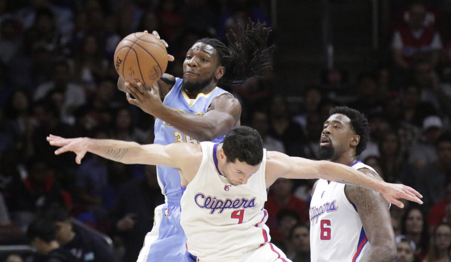 Nuggets power forward Kenneth Faried snatches an offensive rebound over Clippers guard J.J. Redick in the first half.