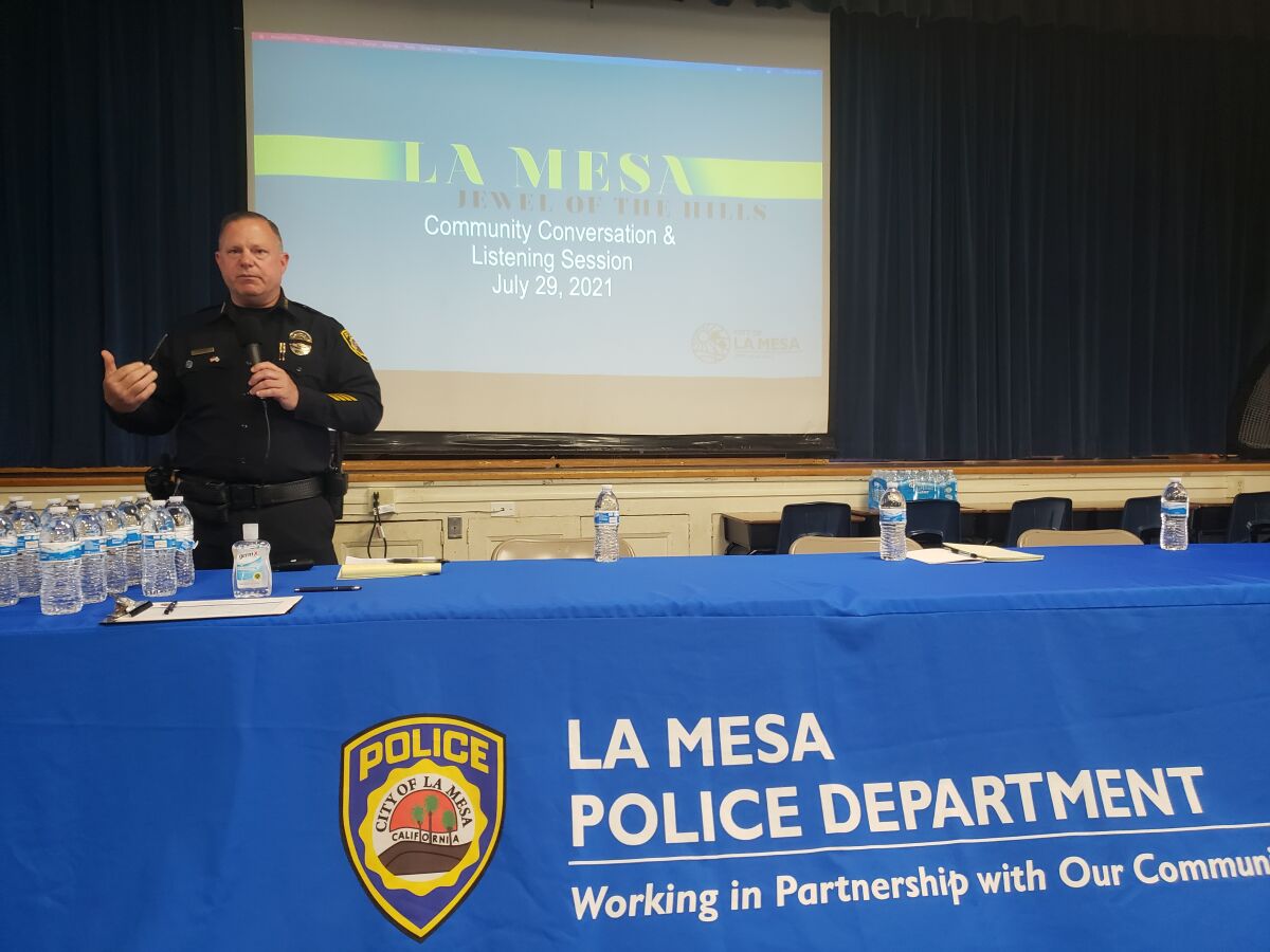 La Mesa Police Chief Ray Sweeney greets community members at listening session Thursday at Rolando Elementary School.