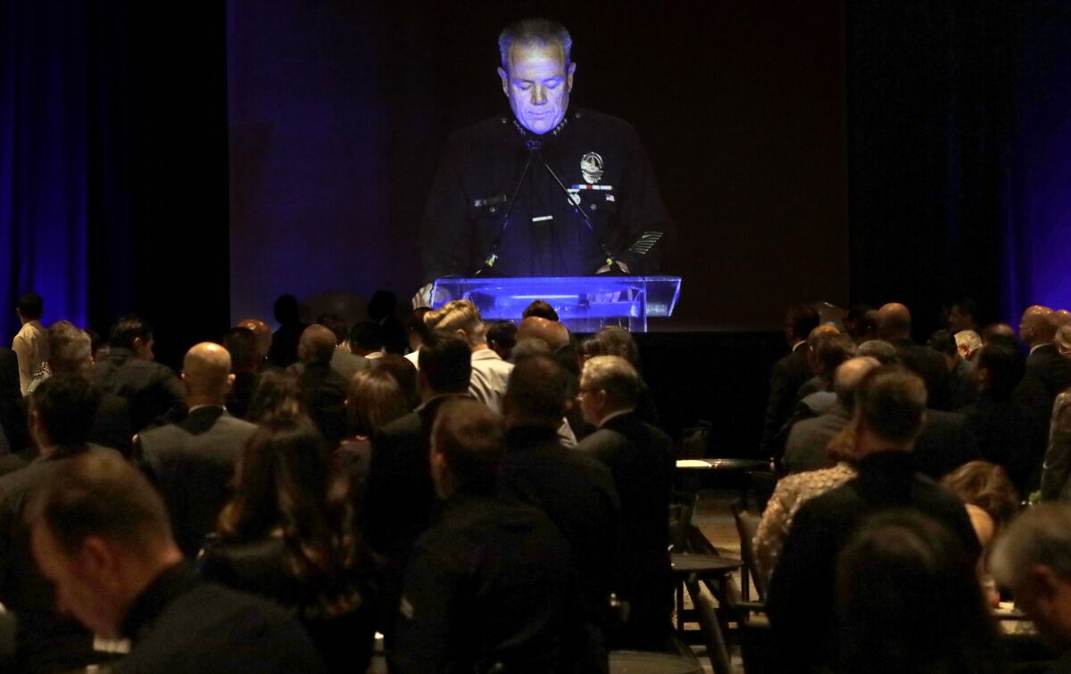 LAPD Chief Michel Moore, on a video screen.