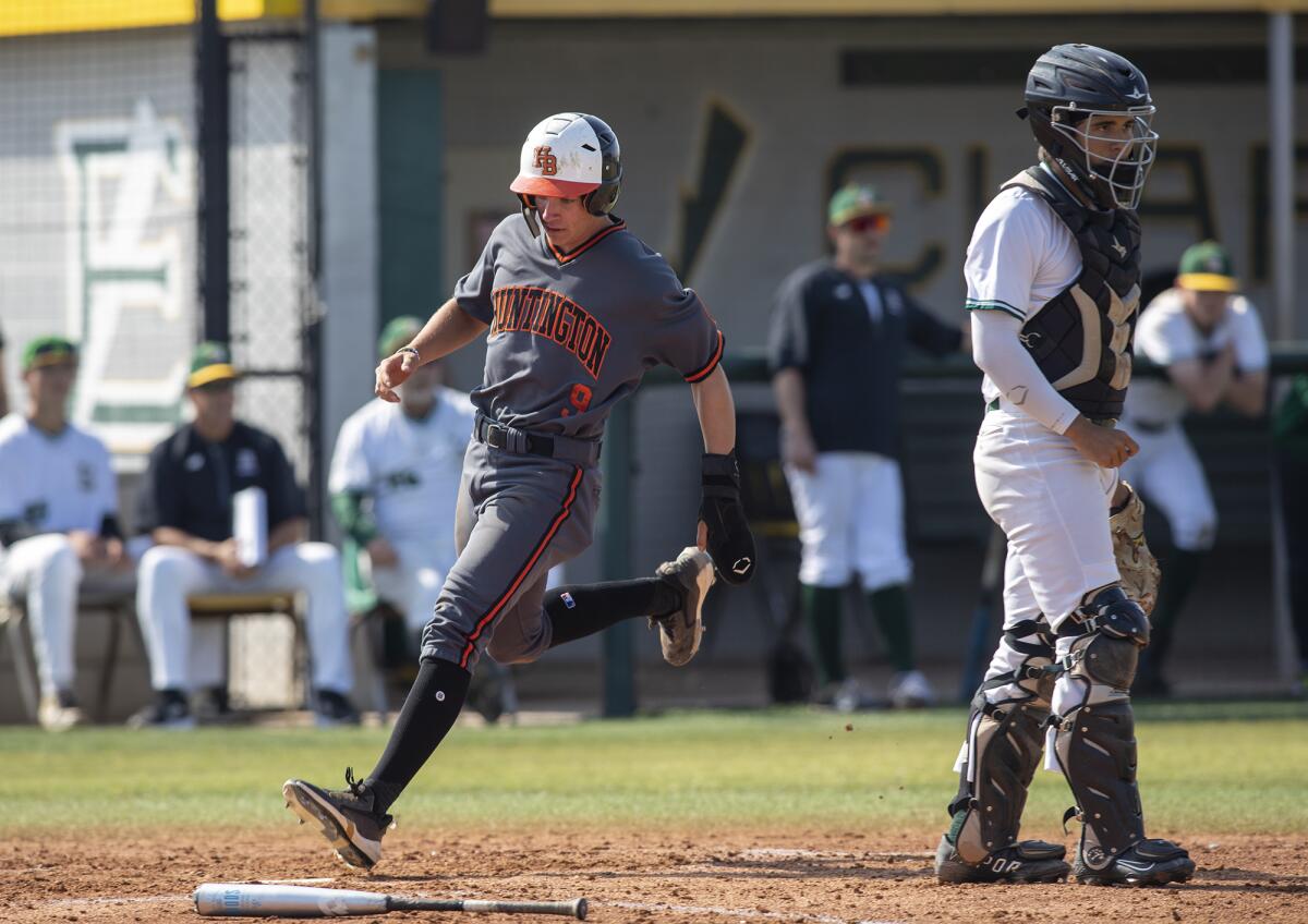 Huntington Beach's Aiden Espinoza scores the only run in the third inning against Edison during a Surf League game on Friday.
