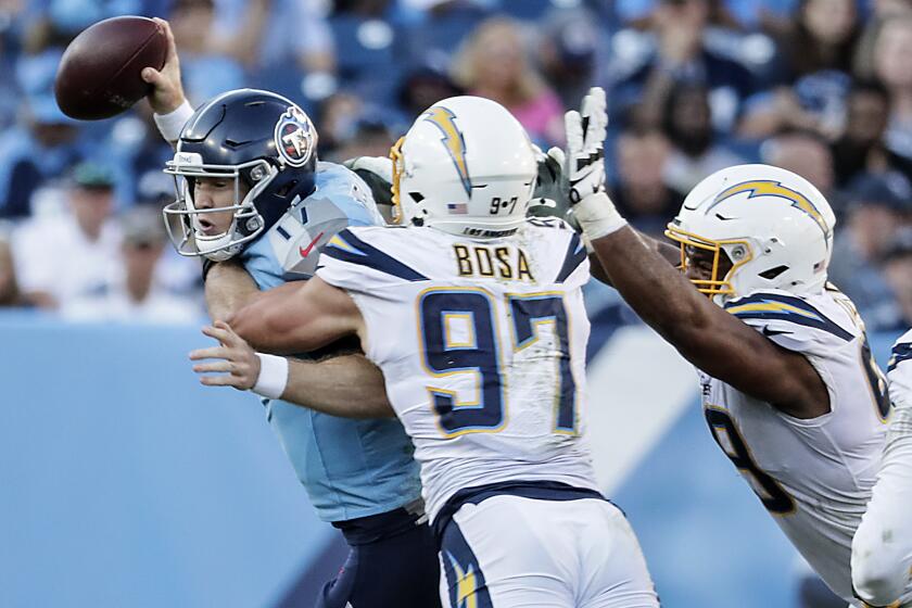 NASHVILLE, TN, SUNDAY, OCTOBER 20, 2019 -Los Angeles Chargers defensive end Joey Bosa (97) sacks Tennessee Titans quarterback Ryan Tannehill (17) during second half action at Nissan Stadium. (Robert Gauthier/Los Angeles Times)