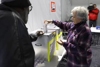Martha Morris casts her ballot at a vote by mail dropbox during primary voting in Las Vegas, on Tuesday, Feb. 6, 2024. (Bizuayehu Tesfaye/Las Vegas Review-Journal via AP)