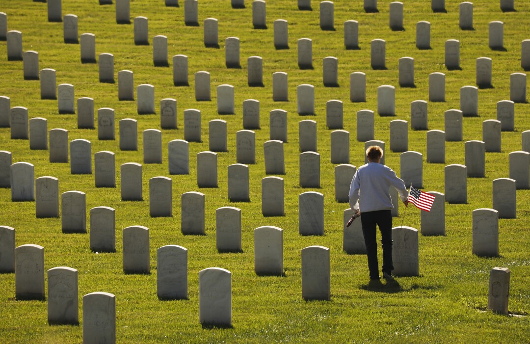 Julie Robinson brought over 100 flags to place on grave markers to honor Veterans Day at Los Angeles National Cemetery.