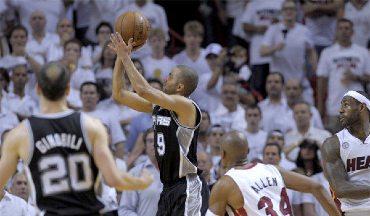 Tony Parker takes a shot late in the fourth quarter in front of teammate Manu Ginobili and Miami's Ray Allen and LeBron James during the Spurs' 92-88 victory over the Heat in Game 1 of the NBA Finals.