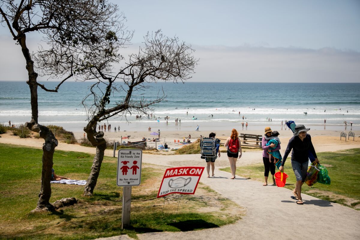 Signs at Powerhouse Park implore park and beachgoers to wear masks on Tuesday.