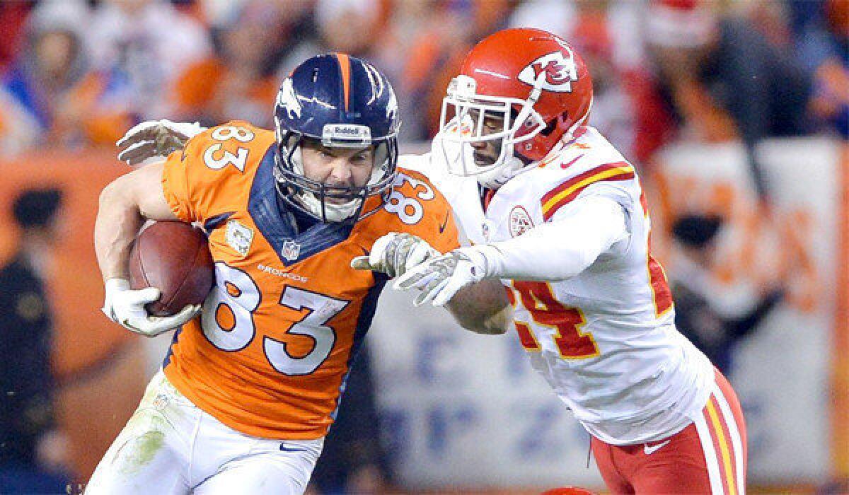 Denver wide receiver Wes Welker picks up a first down in front of Kansas City cornerback Brandon Flowers on Sunday. Welker suffered a concussion and exited the game in the fourth quarter of the Broncos' 27-17 win over the Chiefs.