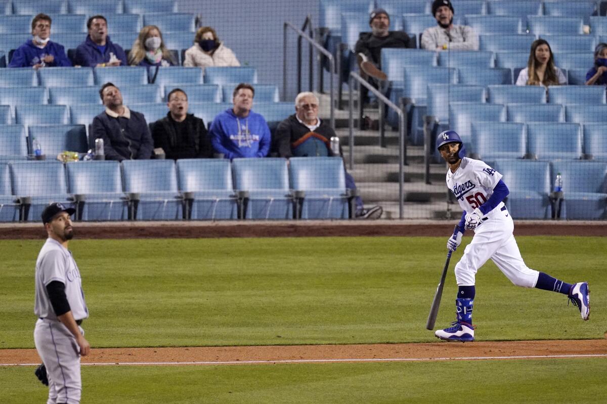 Dodgers right fielder Mookie Betts watches his home run off Colorado Rockies starting pitcher Antonio Senzatela.