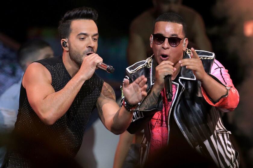 FILE - This April 27, 2017 file photo shows singers Luis Fonsi, left, and Daddy Yankee during the Latin Billboard Awards in Coral Gables, Fla. The success of their hit song "Despacito," has stretched beyond its Latin audience, becoming the yearâs most recognized song in the United States and other countries, and has opened doors for more Spanish tracks to be played on American radio without English lyrics. (AP Photo/Lynne Sladky, File)