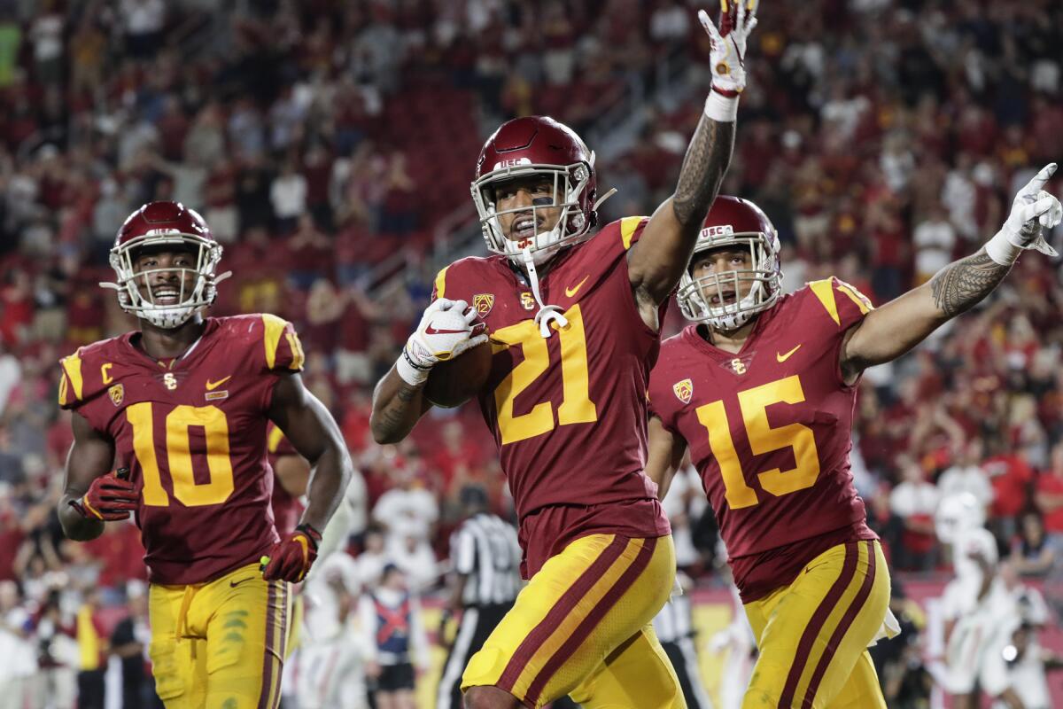 USC defensive back Isaia Pola-Mao celebrates with teammates.