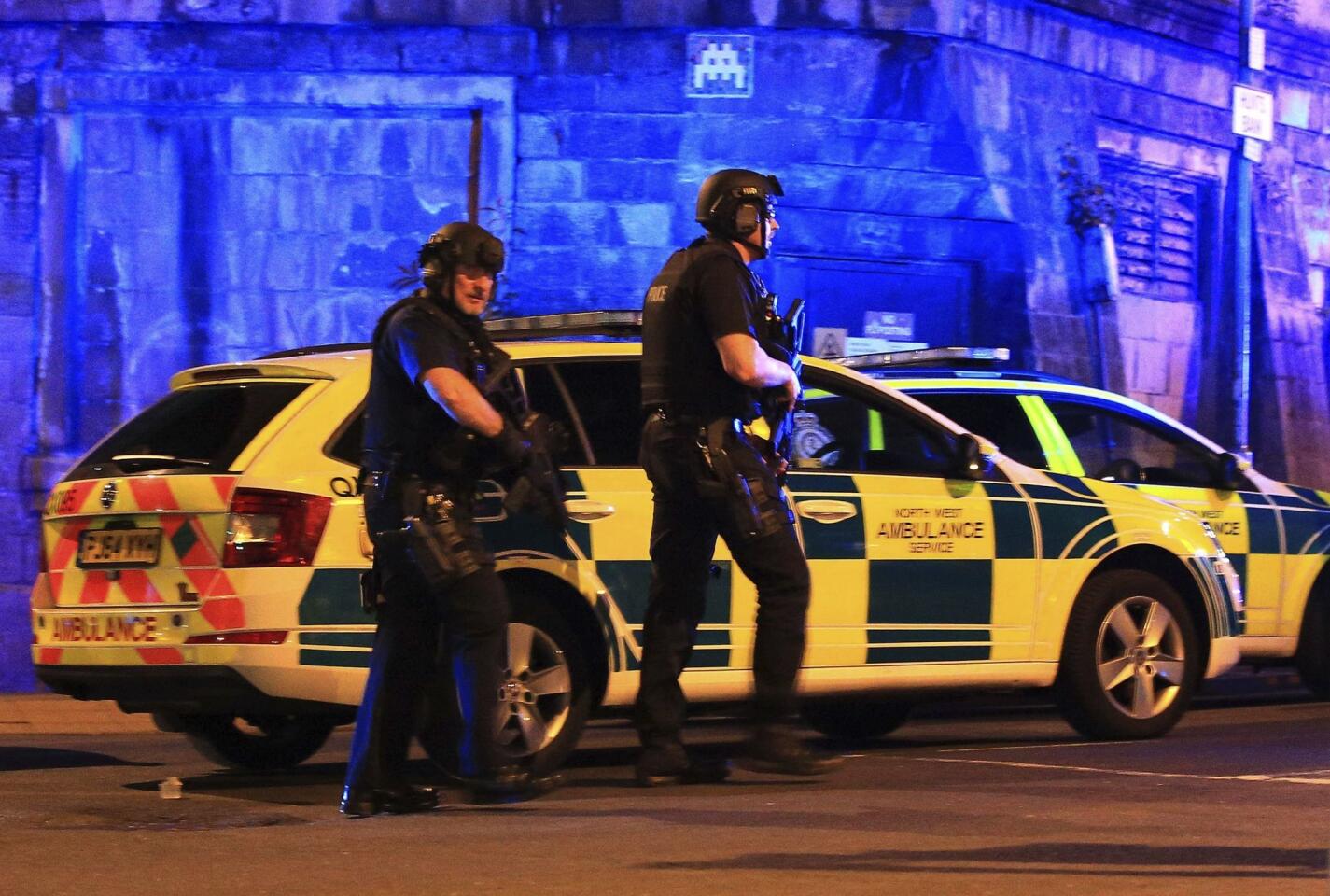 Armed police work at Manchester Arena after reports of an explosion at the venue during an Ariana Grande gig in Manchester, England Monday, May 22, 2017. Several people have died following reports of an explosion Monday night at an Ariana Grande concert in northern England, police said. A representative said the singer was not injured.