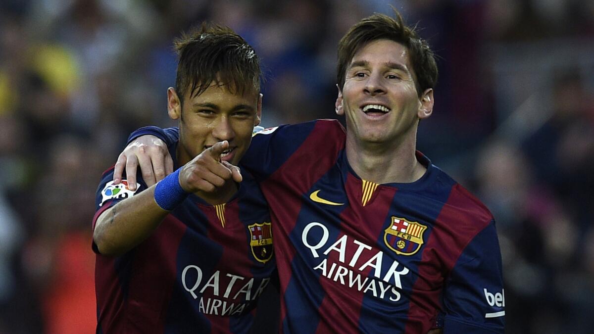 Bracelona FC's Neymar, left, and Lionel Messi celebrate after a goal during a Spanish league match against Getafe on April 28.