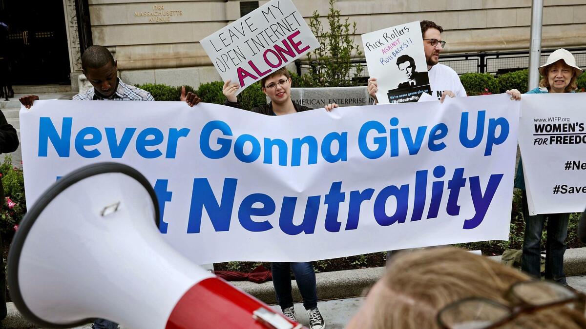 Demonstrators show their support for net neutrality before a May 5 speech in Washington by Federal Communications Commission Chairman Ajit Pai.