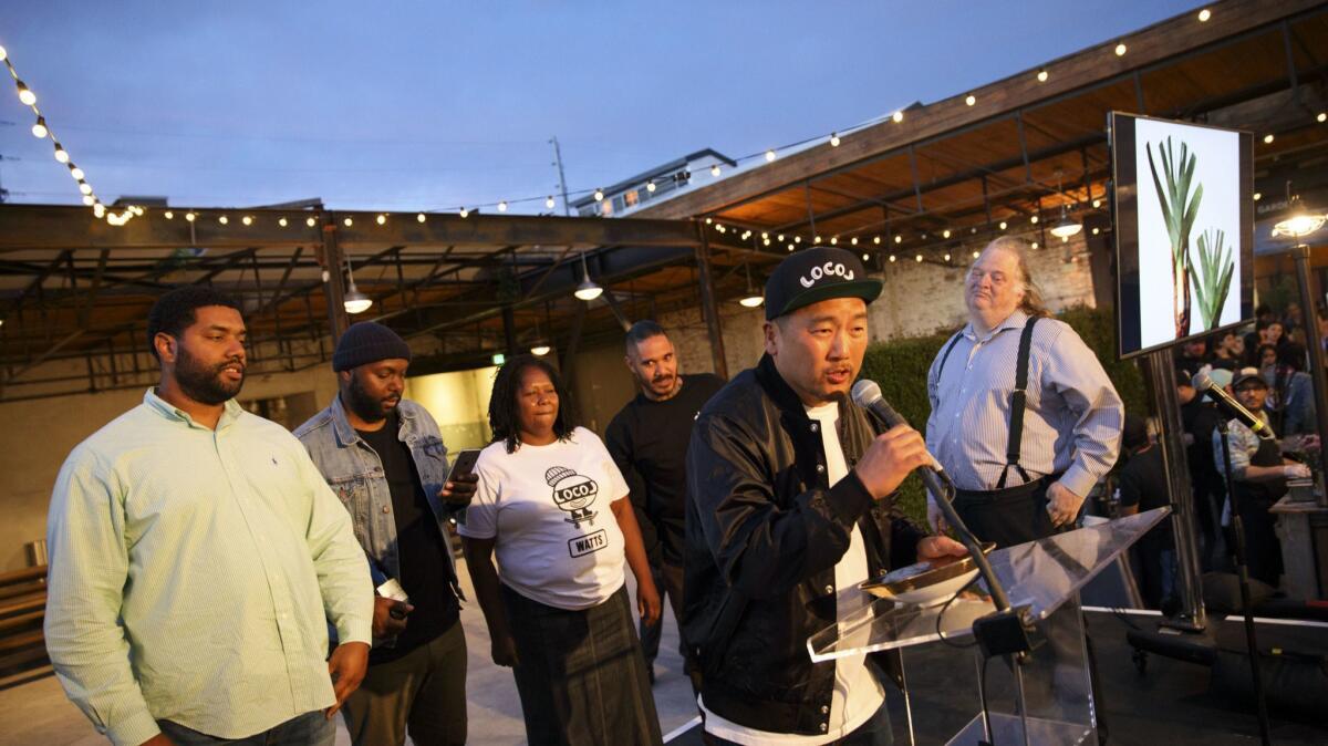 Chef Roy Choi of Locol is presented with the Restaurant of the Year award by critic Jonathan Gold during the L.A. Times Food Bowl launch party on April 27, 2017.