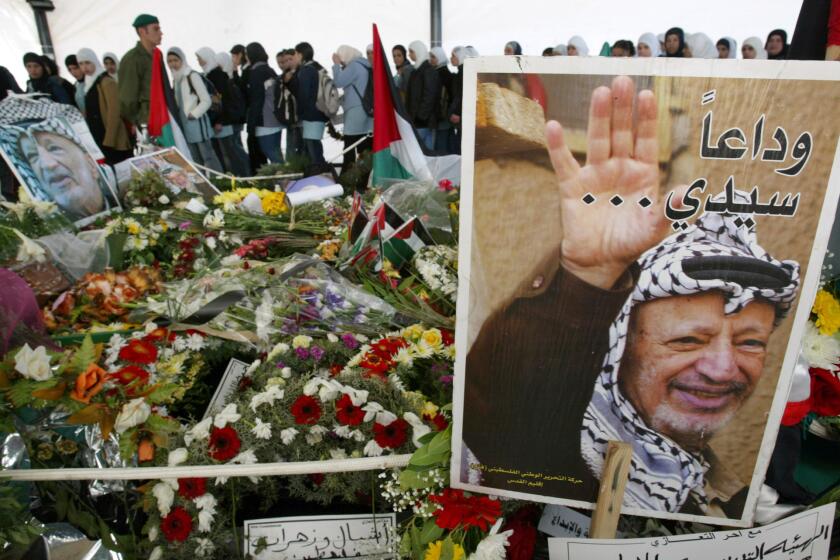 Palestinian leader Yasser Arafat, who died nine years ago at a Paris hospital after exhibiting symptoms doctors thought to be from influenza, was likely poisoned by the radioactive isotope polonium-210, Swiss forensic scientists have concluded in a report released Wednesday. The late PLO leader was entombed in Ramallah on Nov. 21, 2004, as seen in this photo.