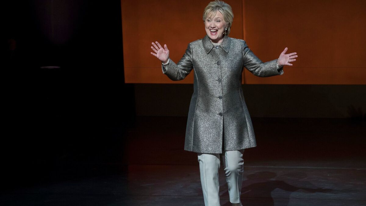 Hillary Clinton reacts to applause as she arrives on stage at Lincoln Center.