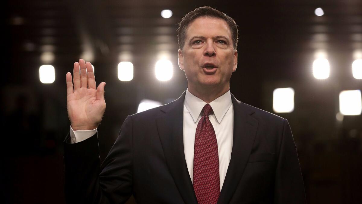 Former FBI Director James Comey is sworn in while testifying before the Senate Intelligence Committee on Capitol Hill Thursday.