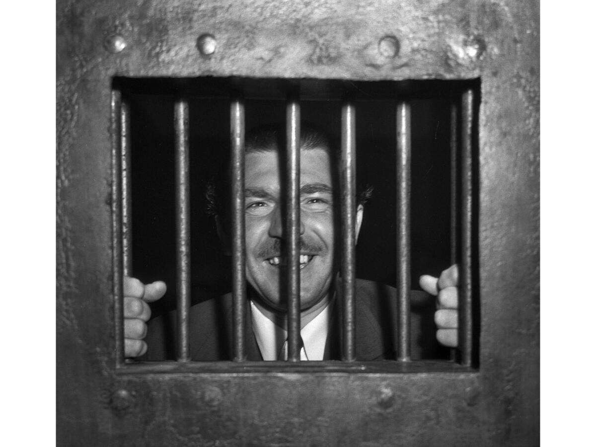 April 10, 1936: Andrew Schwarzman, writer, is shown behind bars after disturbing the peace. He was singing under a window of the Cecil De Mille home.