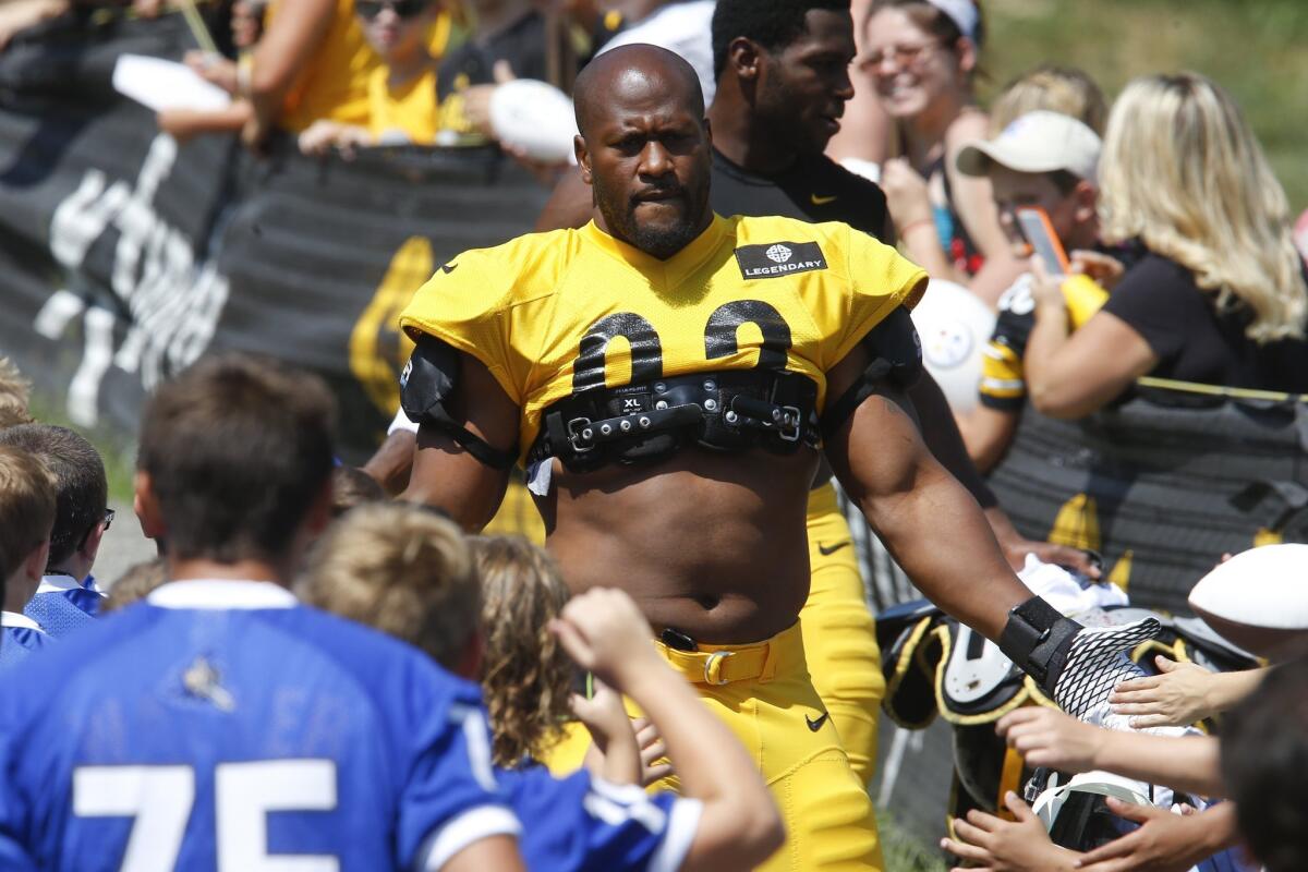 Outside linebacker James Harrison greets fans at Steelers training camp in Latrobe, Pa., on Tuesday.
