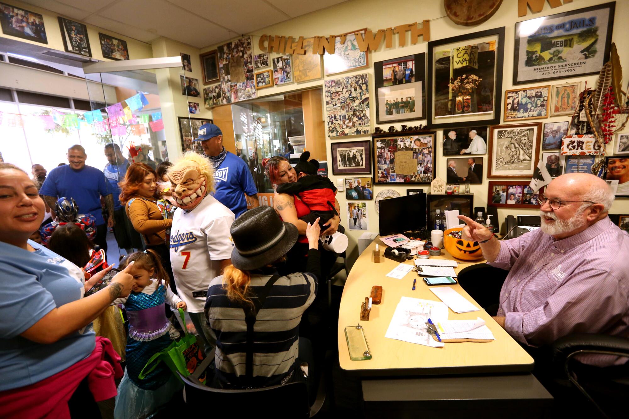 Boyle welcomes  parents and their children, dressed for Halloween,   in his office  