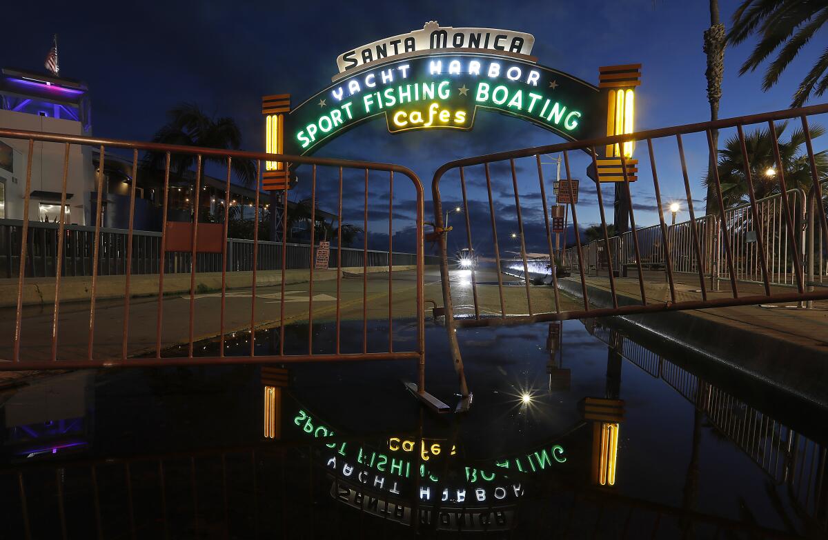 A security gate blocks entry to the Santa Monica Pier