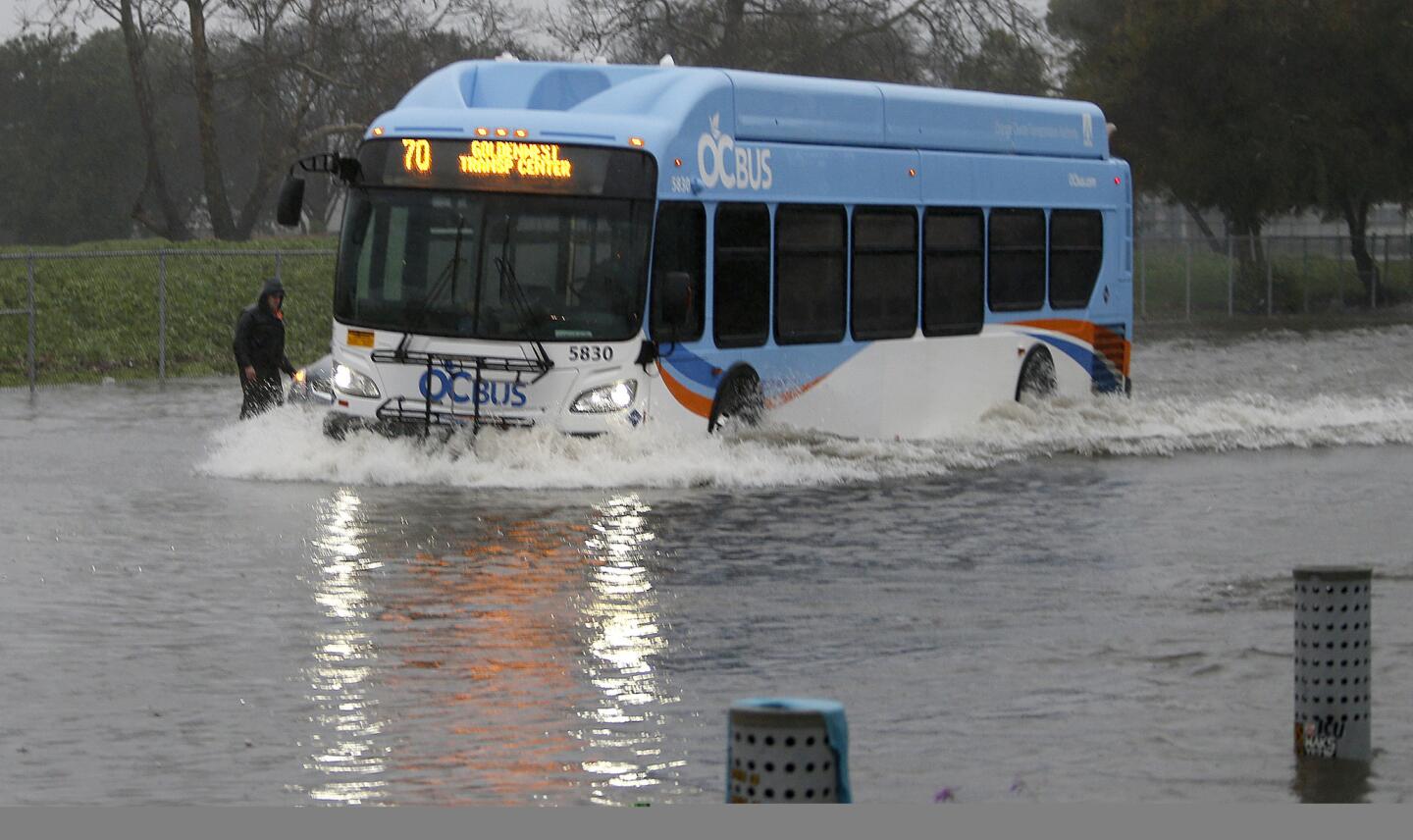 Bus navigates flooded Heil Avenue