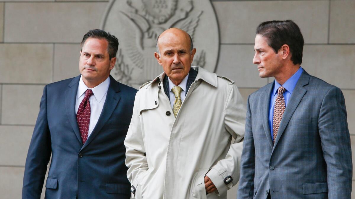 Former Los Angeles County Sheriff Lee Baca, center, leaves federal court, where prosecutors announced they will retry him on charges of obstructing an FBI investigation.